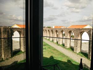 a view from a window of an old building at &Tales Suites - Óbidos in Óbidos +17 photos