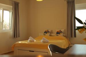 a bedroom with a bed with towels on it at Oleander Villa in Rafina