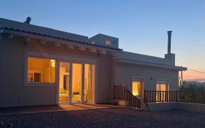 a house with large glass doors on the side of it at Oleander Villa in Rafina +12 photos