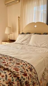 a bedroom with a large bed with a large window at Hemithea Nidri Rooms in Nydri