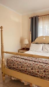 a bedroom with a bed and a window and a bedskirts at Hemithea Nidri Rooms in Nydri +47 photos