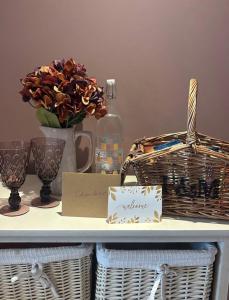 a shelf with baskets and a vase with flowers at Southeast Getaway in Limerick +1 photo