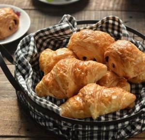 a basket of pastries sitting on top of a table at Hôtel Le Chastellan in Valberg +15 photos