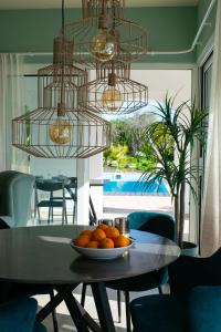 a bowl of oranges on a table in a dining room at Boutique Guesthouse-Moncarapacho in Moncarapacho