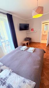 a bedroom with a large bed and a window at MERKADO in Darlowko +35 photos
