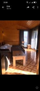 a room with two beds and a table in it at Syuzn Resort in Goris