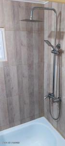 a shower with a glass door in a bathroom at Yahweh temporarios in Río Grande