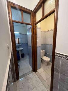 a bathroom with a toilet and a shower and a sink at Residence el baraka in Bou Zadjar +6 photos
