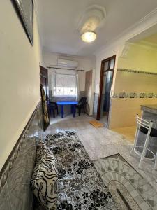 a living room with a couch and a table at Residence el baraka in Bou Zadjar