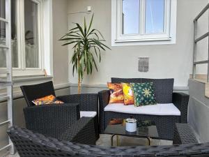 a patio with two chairs and a table with pillows at Mariazellerhof Room 015 in Sankt Pölten
