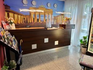 a kitchen with a large counter with clocks on the wall at Atlas Berlin Hotel in Berlin