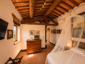 a bedroom with a bed and a wooden ceiling at Il cielo di Anghiari Guest house in Anghiari
