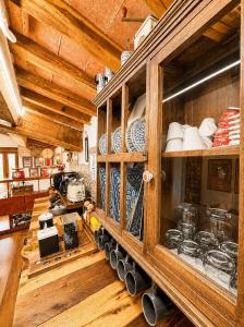 a kitchen with a large wooden cabinet with dishes at Il cielo di Anghiari Guest house in Anghiari +28 photos