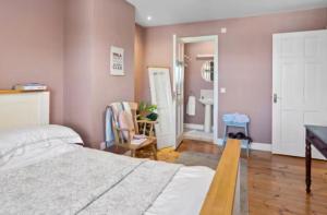 a bedroom with a bed and a bathroom with a sink at Southeast Getaway in Limerick