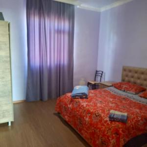 a bedroom with a bed with a suitcase on it at Villa de Ureki in Ureki