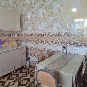 a kitchen with a table and chairs in a room at Villa de Ureki in Ureki