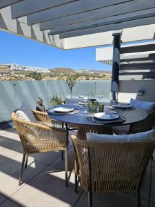a table and chairs on a balcony with a view at Marina Serena in La Cala de Mijas
