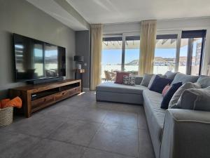a living room with a couch and a flat screen tv at Marina Serena in La Cala de Mijas
