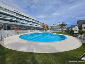 a large swimming pool in front of a building at Marina Serena in La Cala de Mijas