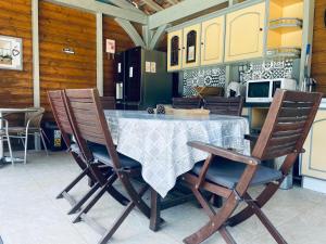 a kitchen with a table and two chairs and a kitchen with a stove at La maison de la Cigale in Forcalqueiret