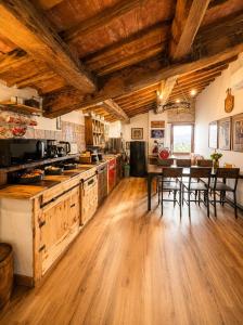 a kitchen with wooden floors and a table with chairs at Il cielo di Anghiari Guest house in Anghiari