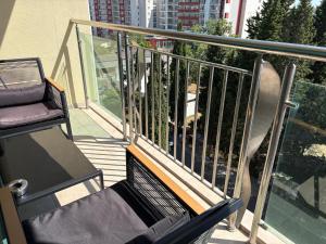 a balcony with a chair and a view of a building at Miramar Palace 612S in Sunny Beach +3 photos