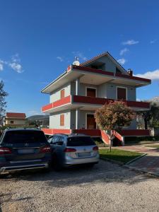 two cars parked in front of a house at 3 Roots Villa in Krujë