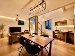 a living room with a wooden table and chairs at Villa Monica EAST in Nagoya