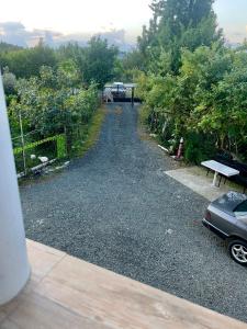 a gravel road with a parked car on it at Villa de Ureki in Ureki +5 photos