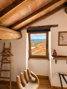 a room with a window and a wooden ladder at Il cielo di Anghiari Guest house in Anghiari
