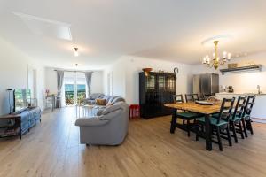 a living room and dining room with a table and a couch at Apartment Ana with private pool in Otok