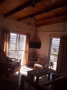 a living room with a couch and a tv at Los 2 Hermanos in Tanti