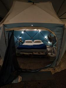 a bed in a tent in a room at Lake N Trails Exotic Glamping in Khālāpur