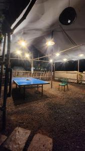 a ping pong table in a tent at night at Lake N Trails Exotic Glamping in Khālāpur