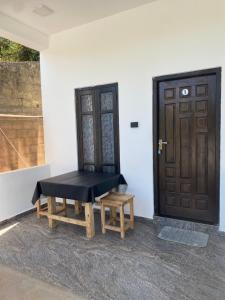 a bench sitting in front of a door at NRT Beach Hotel in Trincomalee