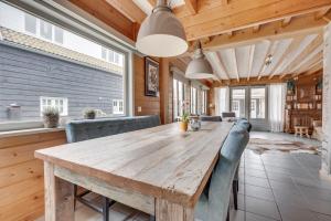 a dining room with a wooden table and chairs at Green House in Koudekerke +9 photos