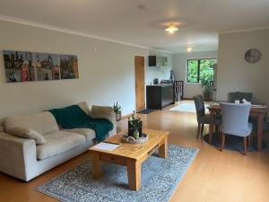 a living room with a couch and a table at Spacious peaceful apartment in Wellington
