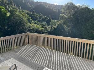 a wooden deck with a view of a mountain at Spacious peaceful apartment in Wellington