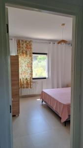a bedroom with a pink bed and a window at Dar Zakia in Soliman +25 photos