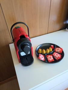 a red flashlight sitting on a counter next to a bowl of food at "FamilyNest" by Staymarilleva1400 in Marilleva