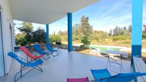 a porch with chairs and a table and a view of the water at Dar Zakia in Soliman