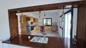 a kitchen with a table and a large mirror at Dar Zakia in Soliman