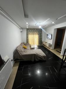 a bedroom with a bed and a television in it at Sweethome in Ariana