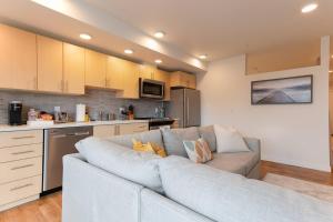 a living room with a couch in a kitchen at Stunning Capitol Hill 1BD Condo in Seattle