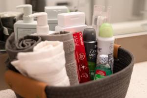a basket full of hygiene items on a counter at Stunning Capitol Hill 1BD Condo in Seattle +21 photos