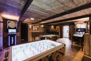 a room with a pool table in a room with at Hotel Le Blanche Neige in Valberg +45 photos