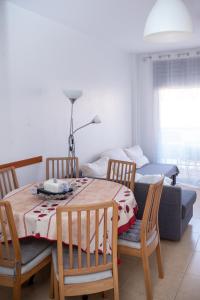 a dining room with a table and chairs and a couch at Boadella-Fenals in Lloret de Mar