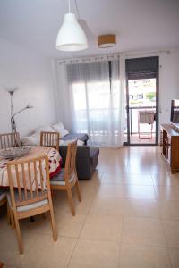 a living room with a table and chairs and a couch at Boadella-Fenals in Lloret de Mar