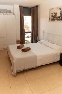 a bedroom with a bed with two pillows on it at Boadella-Fenals in Lloret de Mar +14 photos