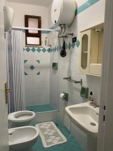 a bathroom with a shower and a toilet and a sink at ZIO DOMENICO Al Vicolo in Castellabate